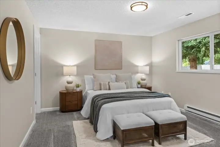 Primary bedroom offers spacious room with large window to the backyard.
