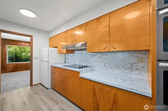 Kitchen has original hand-crafted wood cabinets