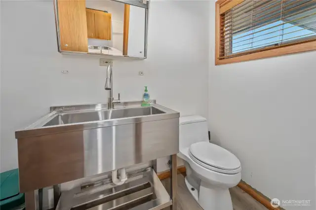 Half bath adjoins laundry; brand new stainless steel utility sink