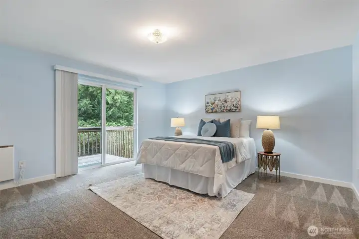 Primary bedroom with walk in closet, 3/4 bath & private deck.
