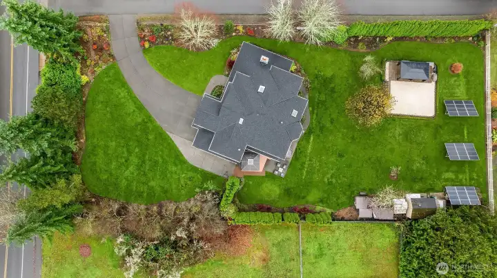 Three solar panels at the rear of the yard.