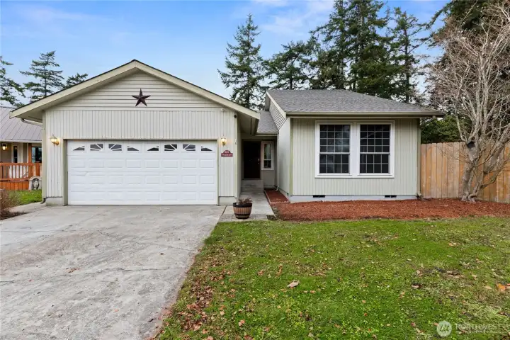 This charming single-level home welcomes you with a tidy façade, attached garage, and a peaceful Northwest setting—perfect for easy living and everyday comfort.