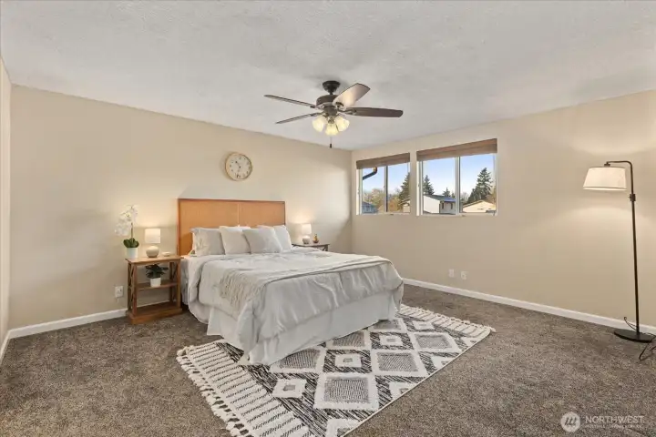 Primary suite bedroom featuring updated ceiling and light fixture, and new baseboards. All new carpeting and baseboards on the second floor.