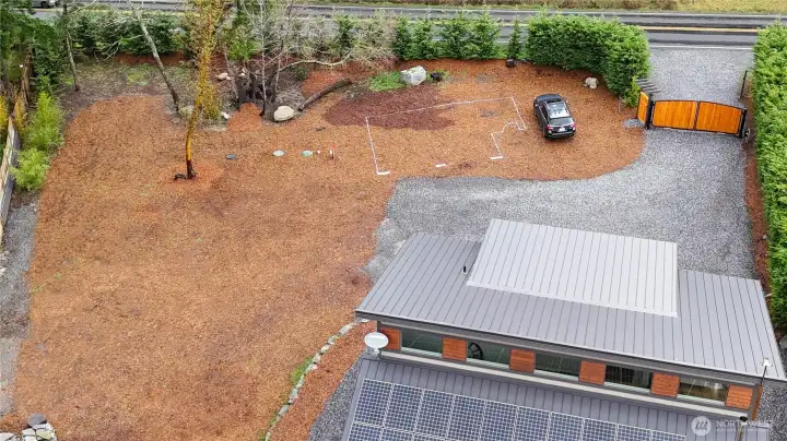 Permitted 2 car garage plans with office space above is outlined.  Power, water and septic in place.  RV hook up also in place and ample parking.