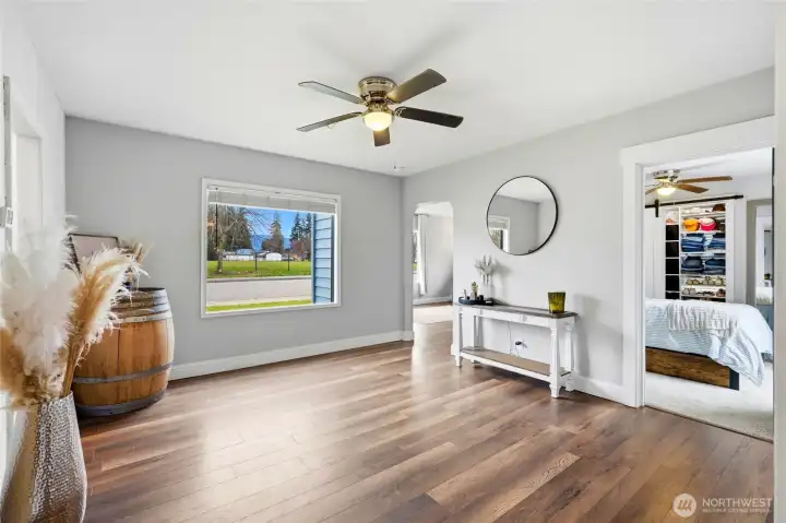 Extra living space with ceiling fan and updated flooring