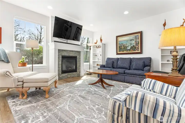 Light and bright great room featuring luxury vinyl plank floors and a cozy gas fireplace—perfect for everyday living and effortless entertaining.