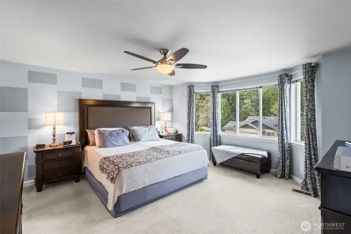 Spacious primary with bay windows.