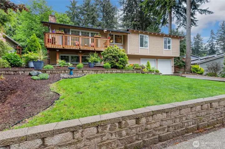 Front yard is landscaped nicely with retaining wall and new front deck to enjoy the summer mornings on.