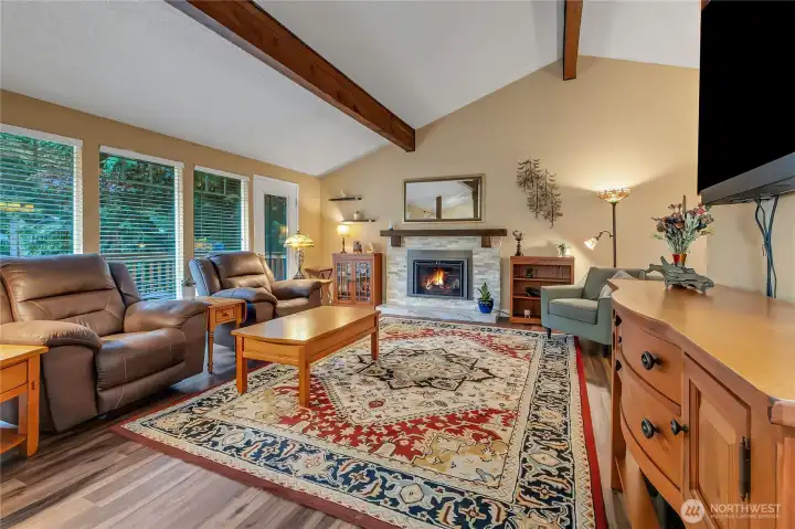 Upstairs living space with wood beams and vaulted cieling.