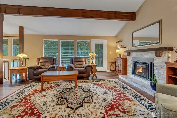 One of two gas fireplace inserts.  Natural light open to deck space off front of the home.