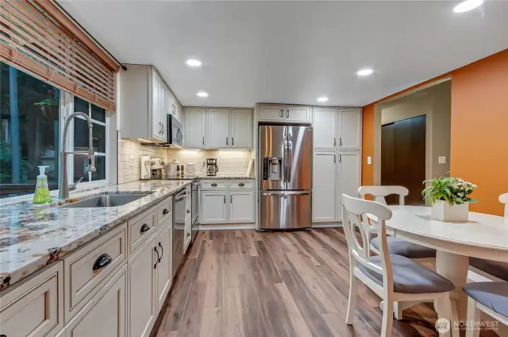 Kitchen with eating space, ample cabinets, stainless steel appliances...all stay!