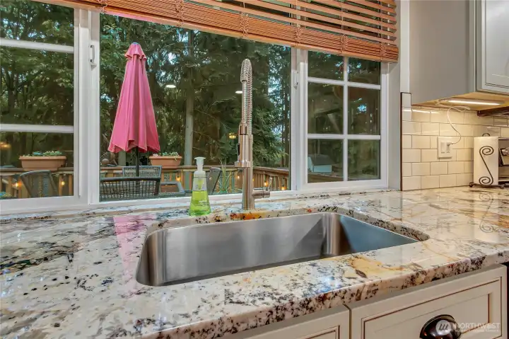 Beautiful view from sink into back yard deck and private back yard.