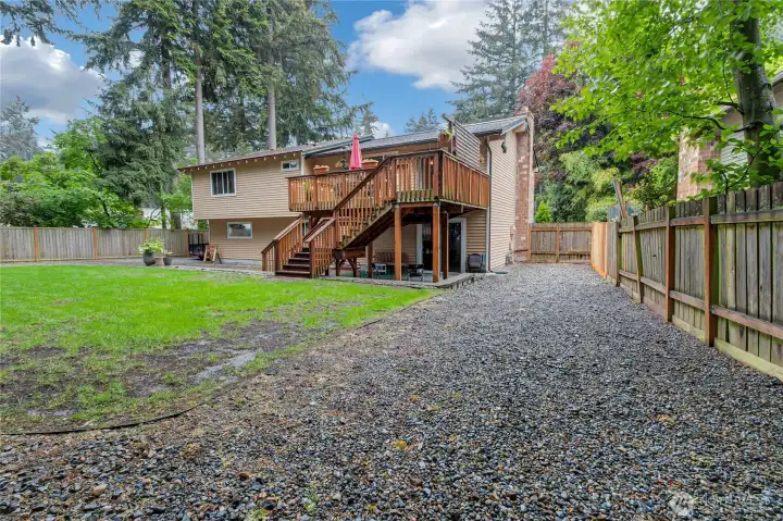 Downstairs patio under deck with extra cement area for entertaining.