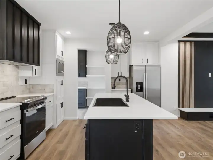 Kitchen with quartz countertops, workstation sink and large island Kitchen with quartz countertops, workstation sink and large island