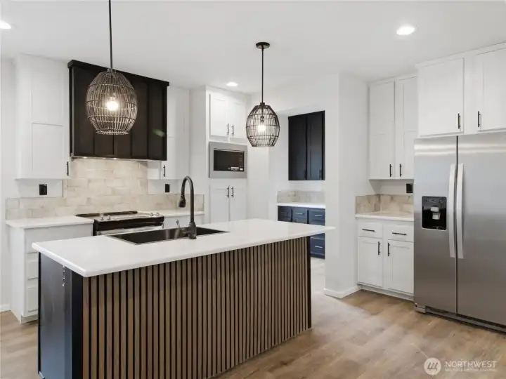Beautiful kitchen with large island and stainless steel appliances Beautiful kitchen with large island and stainless steel appliances