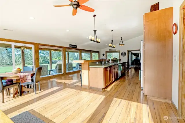 Massive kitchen and dining room area with all the light of the outdoors and all the custom charm a PNW home should have. Expert woodworking, top of the line materials and top level craftmanship throughout the home!  Gas range, bar eating space as well as large table space, top of the line fixures and cabinetry.