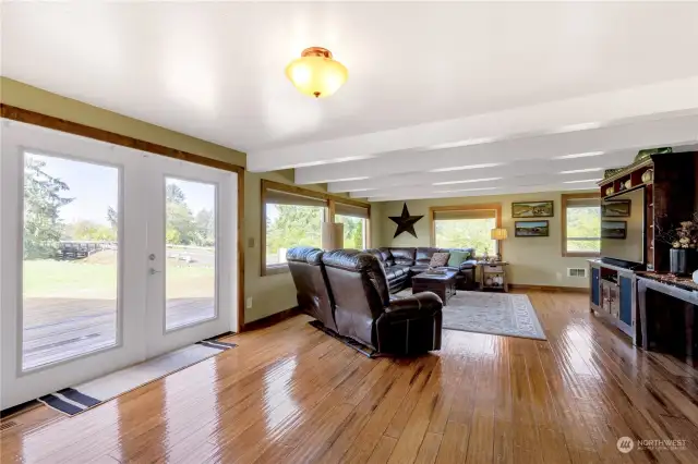 Great room offering living space to relax, watch your favorite movies, spread out and take in the natural light during the day and the stars on clear nights out the French doors to the open deck