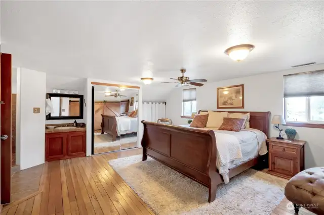 Vintage hardwood floor in this Primary Suite on the second floor . In room vanity in addition to a full bathroom