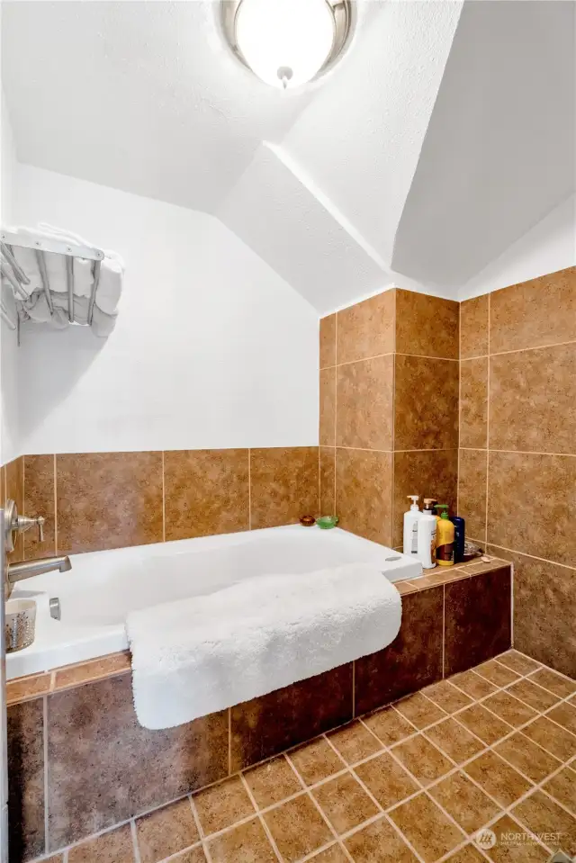 Relax in the jetted tub in the Primary suite's spacious bathroom