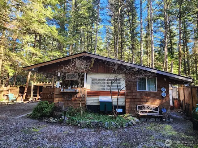 Trailer, porch, and both add-ons under metal roof.