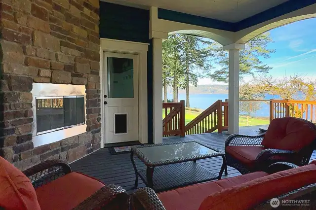 Wrap-around porch with propane fireplace. Sunken hot tub to the right of the photo