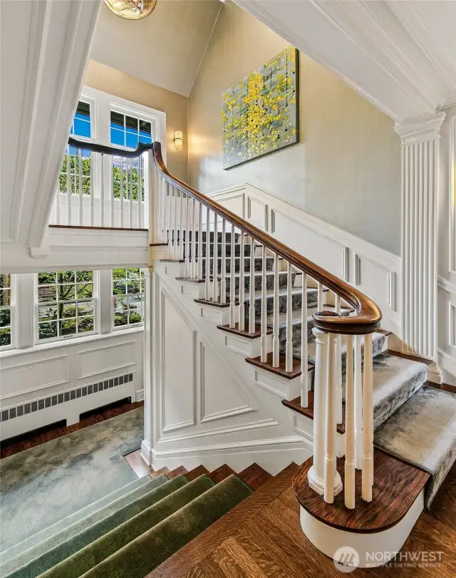 The grand stair curves upward from the Overlook Landing, its balustrade an ode to Edwardian craftsmanship. Bathed in natural light from tall divided windows, the ascent offers both literal and symbolic elevation—a journey through the mansion’s layered legacy.
