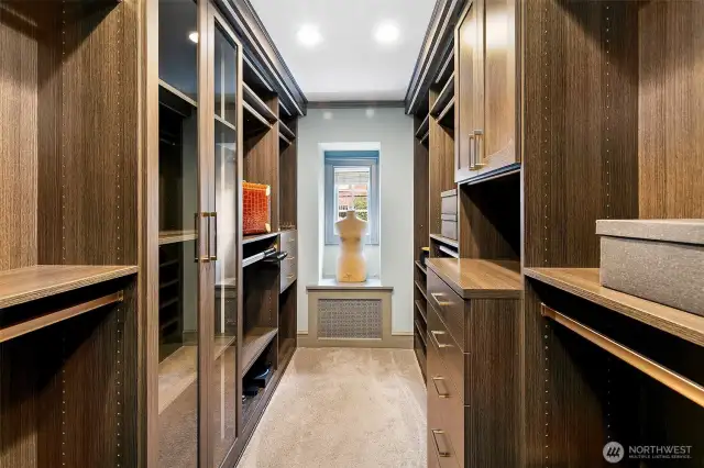 The Wardrobe/Dressing room of the Owner’s Suite delivers boutique-caliber luxury with rich wood finishes, custom shelving, and gallery-style lighting. An elegant passage between private quarters and en suite bath, it’s a daily ritual rendered extraordinary.