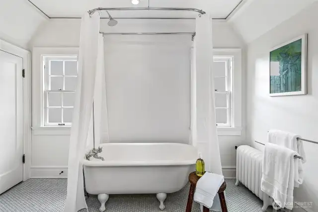 Bathed in soft daylight and pure white serenity, the En Suite Bath for Suite 3 features an original clawfoot tub at center stage—an ode to timeless indulgence. Classic, quiet, and utterly calming, it’s a meditative pause amid the mansion’s layered design story.
