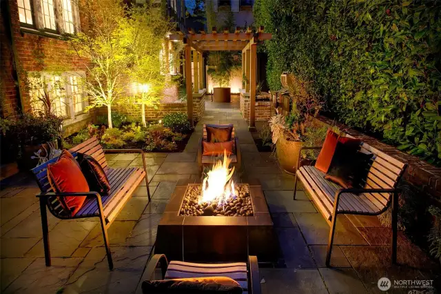 At the heart of the Privacy Courtyard, a fire pit crackles beneath stars and ivy. Surrounded by layered seating, mature plantings, and warm architectural glow, this is a space made for storytelling, stillness, and spirited connection—timeless in feel, unforgettable in function.