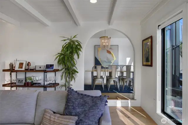 I don't know about you, but I love arched doorways.  What amazing ceiling height and beautiful light captured here dancing into the dining room.