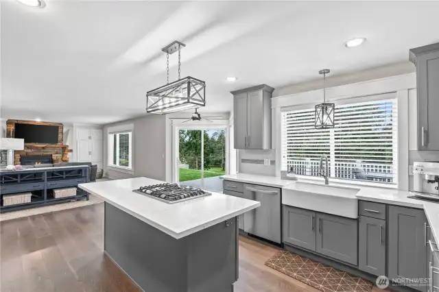 With a farmhouse sink, quartz counters, modern lighting, this kitchen is sure to please