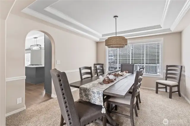 Dining room features upgraded lighting and a chair rail