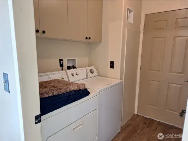Laundry room off kitchen with back door