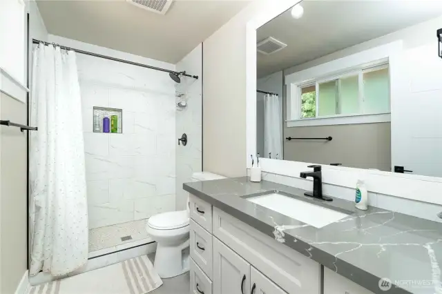 Primary bathroom with walk-in tiled shower