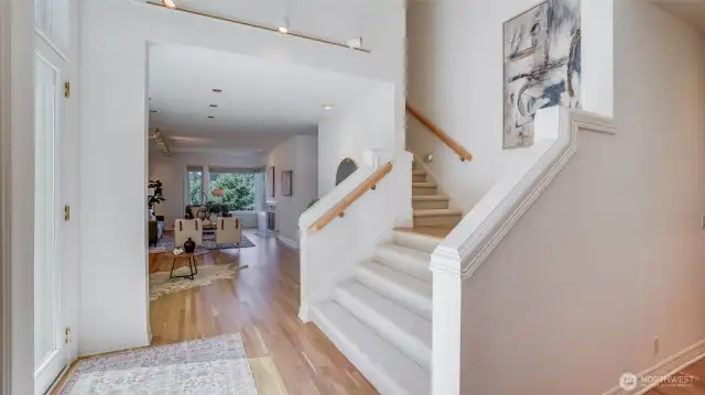 On the main floor, the open concept living and dining areas are warm and welcoming, anchored by two gas fireplaces and filled with natural light.