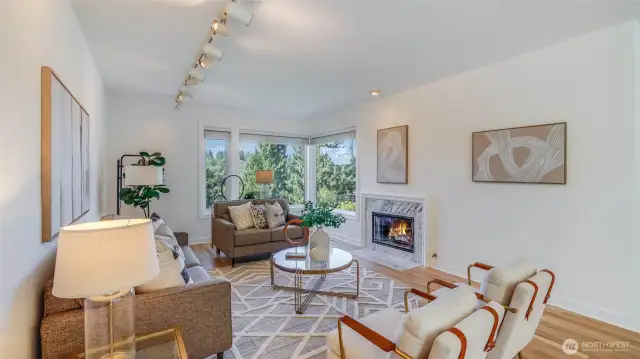 Open concept living and dining areas anchored by two gas fireplaces, one on each side.