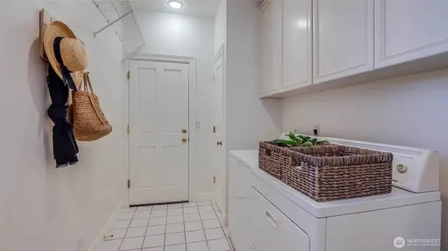 A laundry room conveniently located near the entry from the oversized two-car garage adds everyday ease.
