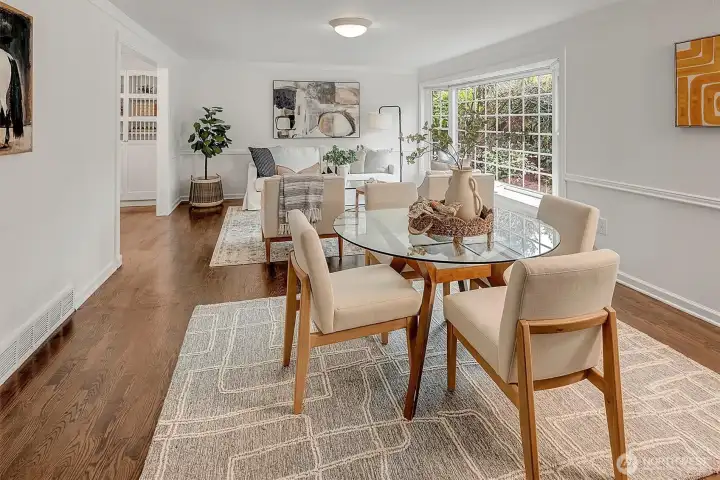 The inviting living and dining spaces feature gleaming hardwood floors.