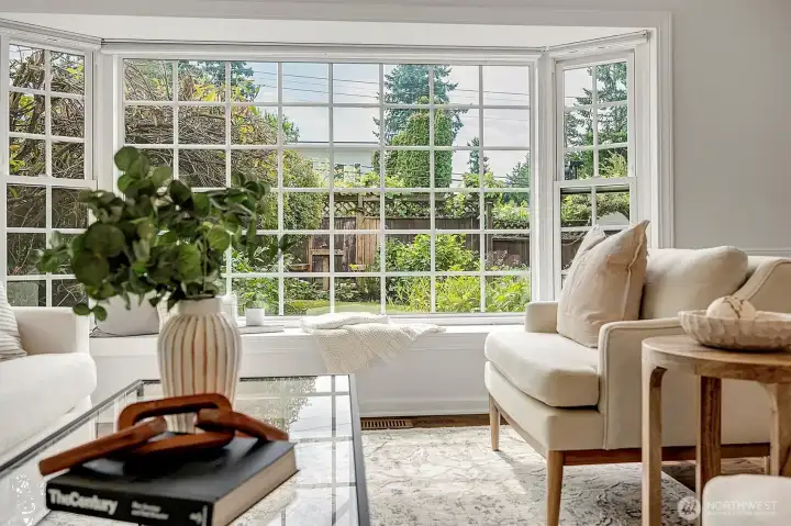 A bay window with a cozy reading nook that overlooks the English-inspired garden.