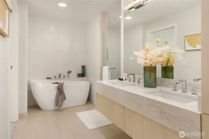 Spa inspired 5-piece primary bath with freestanding tub, walk-in shower, water closet, radiant floor heat, linen storage.