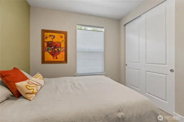 Inviting Guest Retreat – Freshly painted with a soothing green accent wall, this comfortable guest bedroom offers plush carpet, a large window for natural light, and ample space for a queen bed and seating. Perfect for visitors, a home office, or flex space.