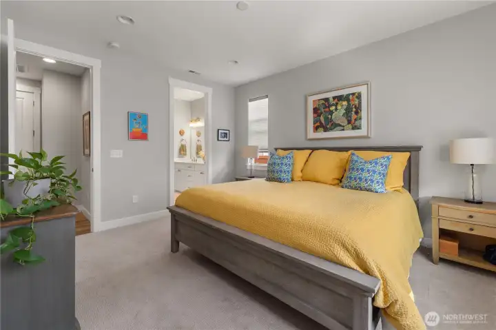 Primary Suite with En-Suite Bath – Generous bedroom with plush carpet and natural light, opening to a private bathroom with dual sinks for everyday convenience.