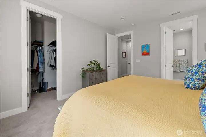 Primary Suite with Walk-In Closet – Comfortable bedroom retreat featuring plush carpet, an en-suite bath, and a spacious walk-in closet for easy organization.
