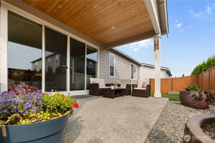 Covered Outdoor Living – Spacious concrete patio with overhead cover and room for seating or dining, perfect for year-round relaxation and entertaining.