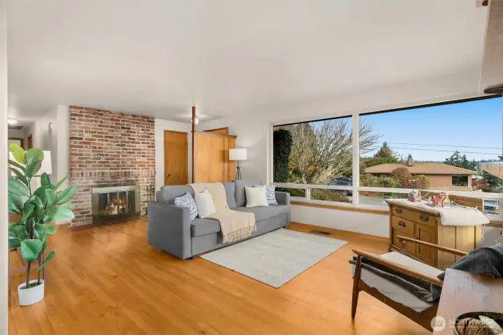 Wood floors, fireplace, and MCM charm