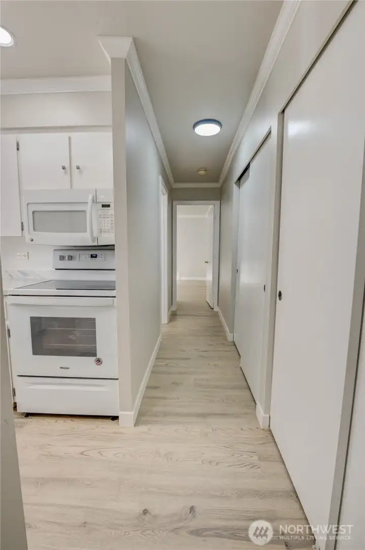 Hallway front on view from living room. Kitchen opening to the left.
