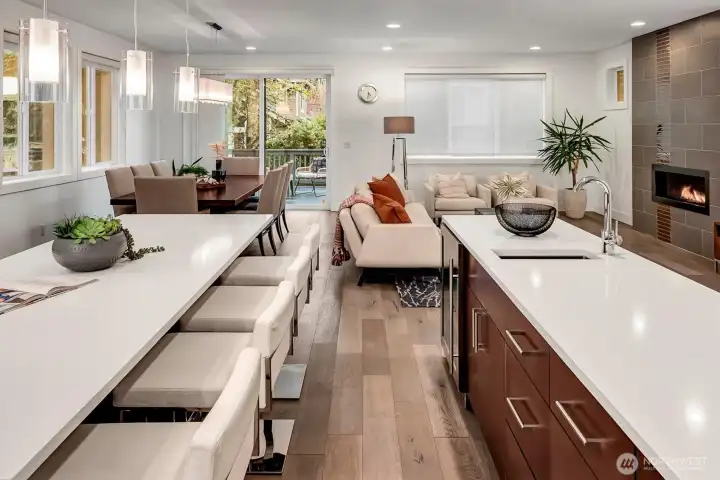 Chef's prep island with a sink and wine/beverage refrigerator, quartz countertops.