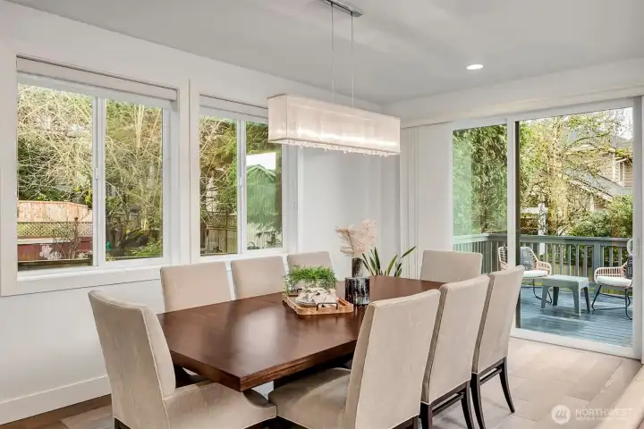 Large dining area windows fill the space with natural light and overlook the backyard.
