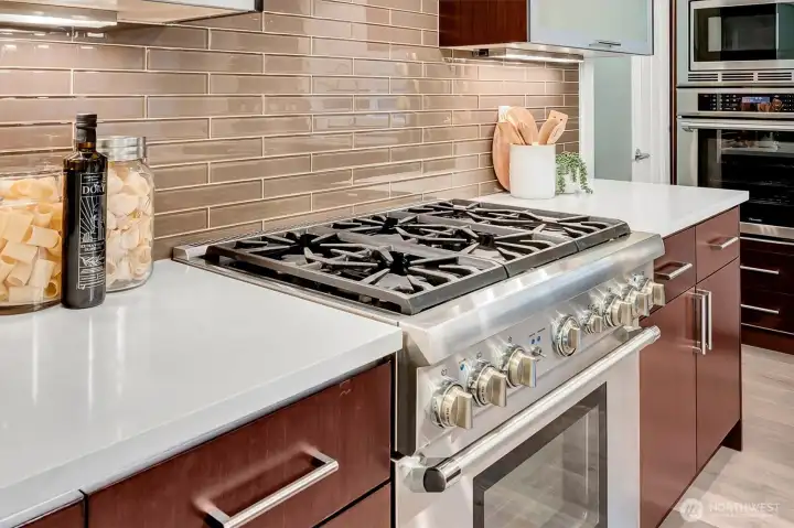 Double ovens, and a 6-burner gas cooktop.