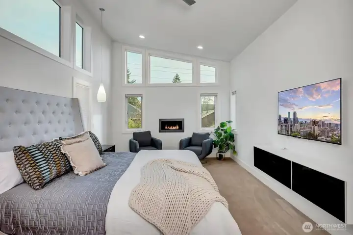 The expansive primary suite offers vaulted ceilings.